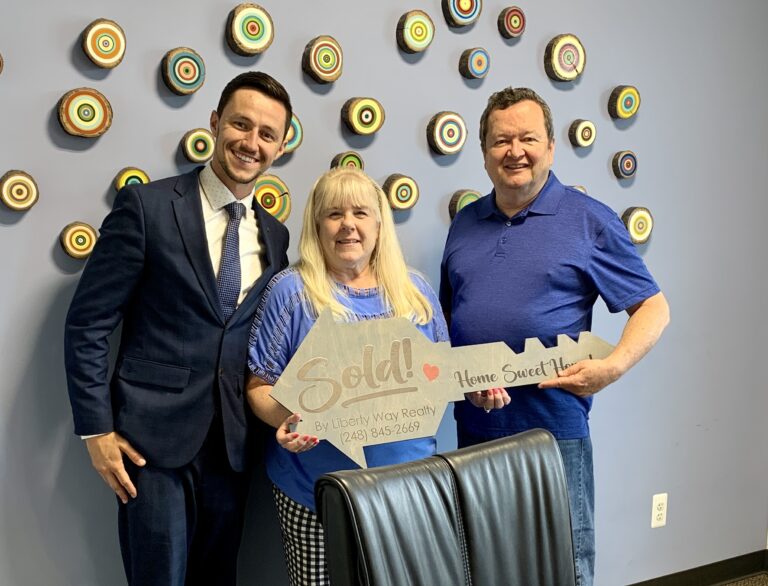 Keith Fitzpatrick III, Realtor, with clients after they purchased a waterfront condo on Stony Lake in Oxford, Michigan.