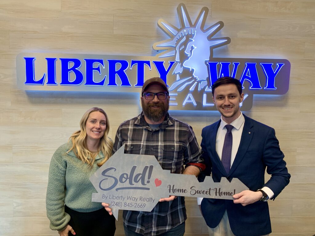 Keith Fitzpatrick III, Realtor, with investor clients after purchasing three Airbnb properties in Michigan.