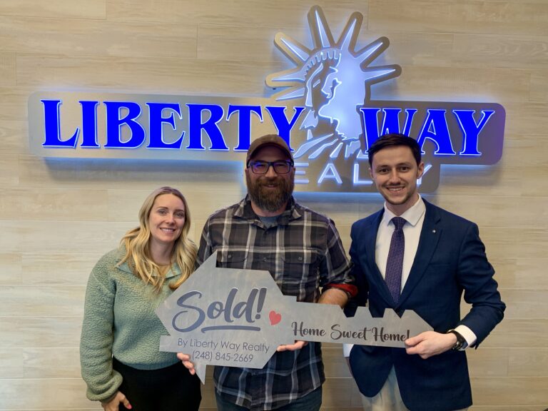 Keith Fitzpatrick III, Realtor, with investor clients after purchasing three Airbnb properties in Michigan.