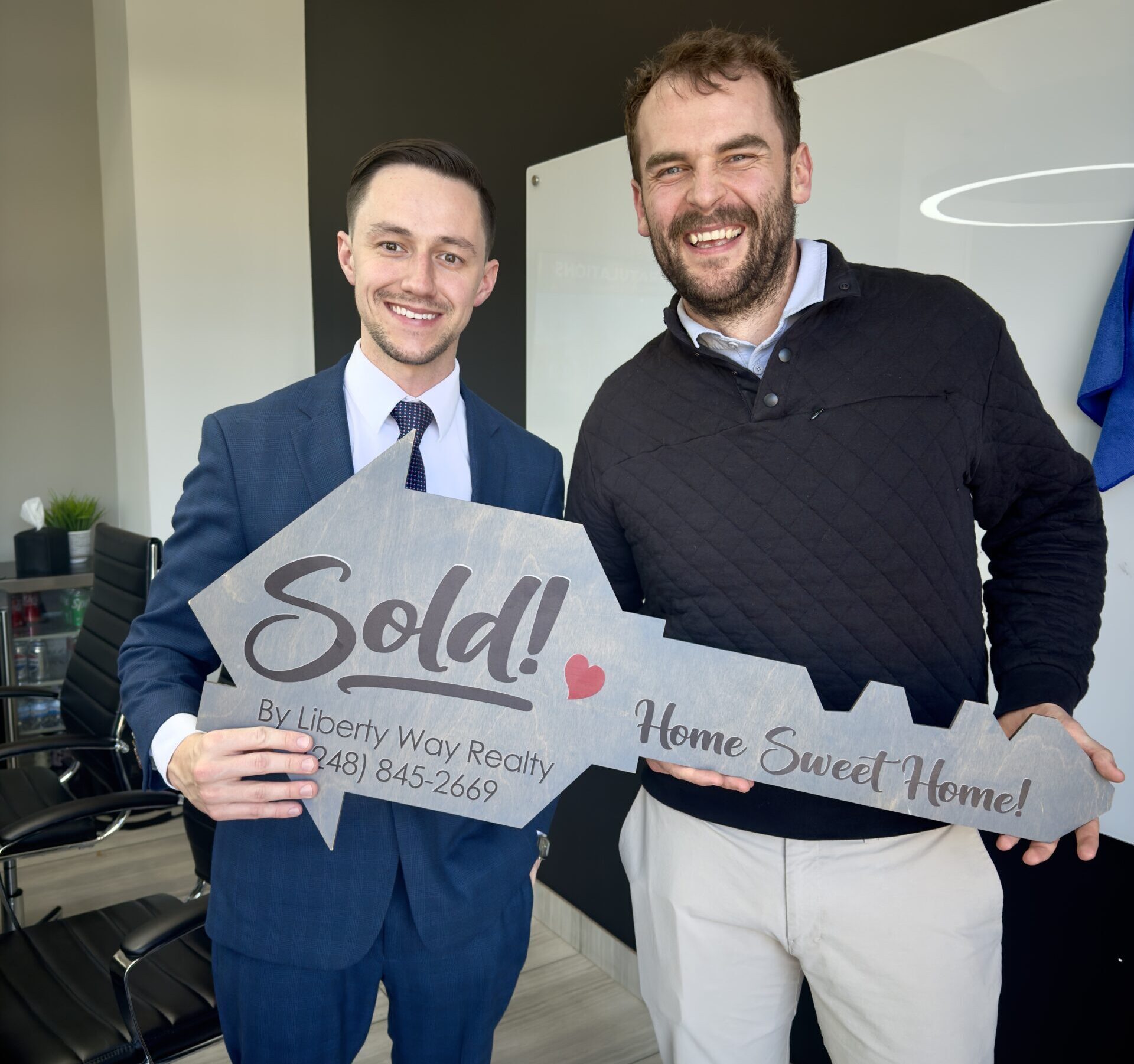 Keith Fitzpatrick III, Realtor, with a client at closing after the purchase of a first home in Madison Heights, Michigan.