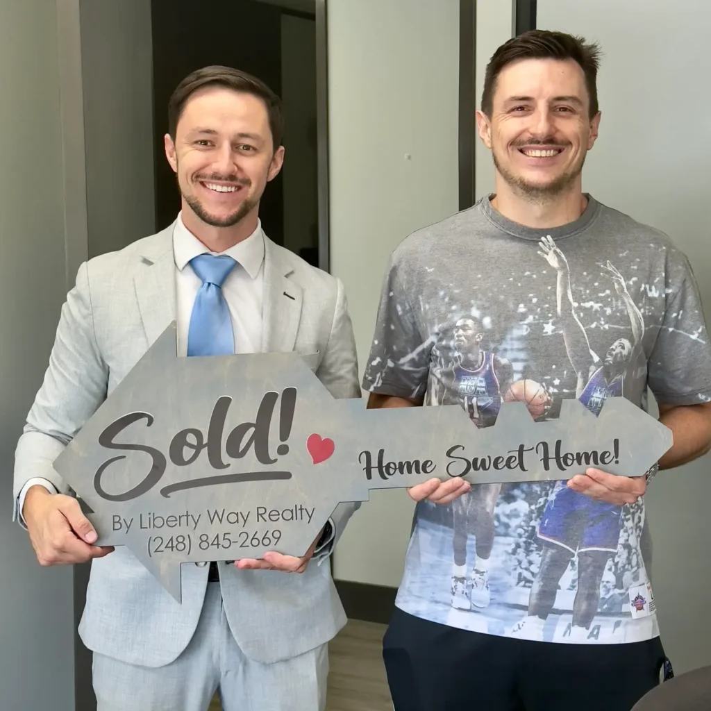 Keith Fitzpatrick III, Realtor, with buyer client Andrew after closing on his Michigan home.