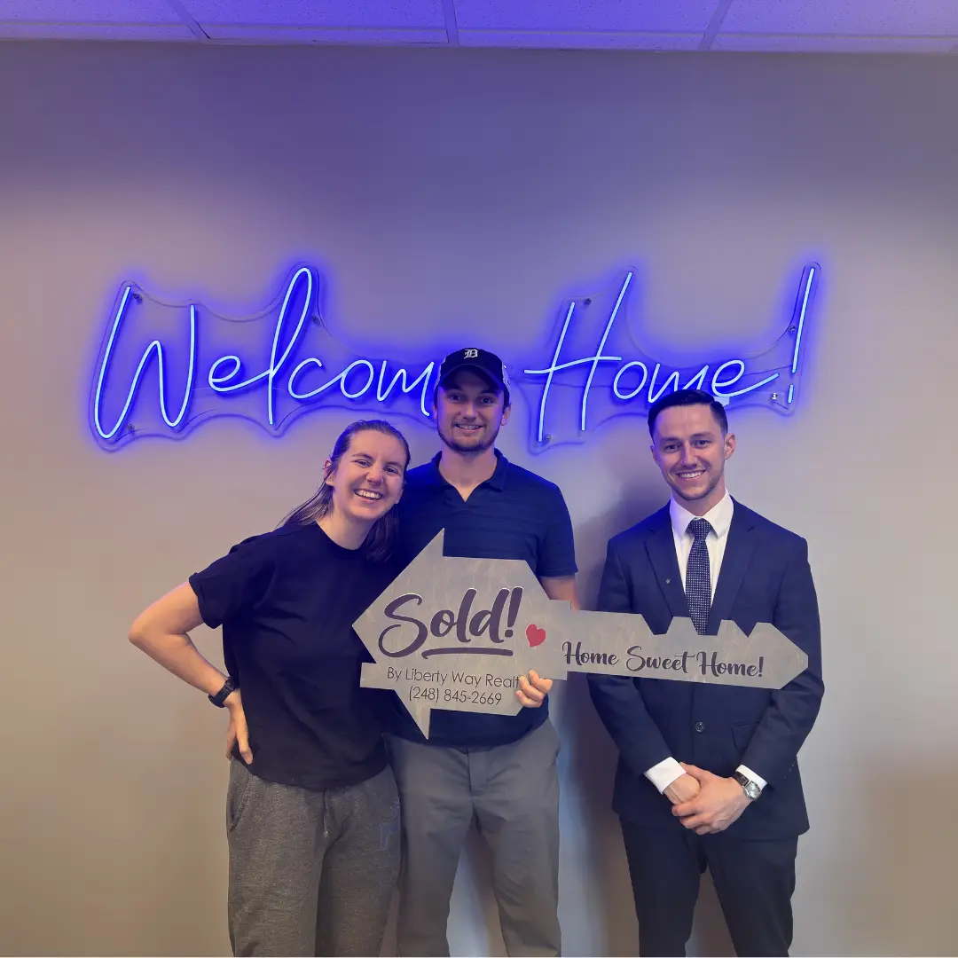 Keith Fitzpatrick III, Realtor, with first-time homebuyers after closing on their home in Rochester Hills, Michigan.